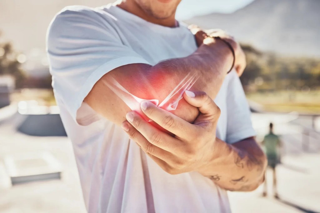 Person holding a sore elbow